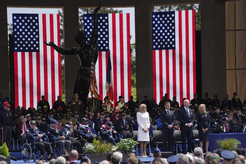 French President Emmanuel Macron, 2nd left, his wife Brigitte Macron, left, and US President Joe Biden, center right, and first lady Jill Biden attend a ceremony together with World War II veterans at an US cemetery near Colleville-sur-Mer Normandy, Thursday, June 6, 2024. World War II veterans from across the United States as well as Britain and Canada are in Normandy this week to mark 80 years since the D-Day landings that helped lead to Hitler's defeat. (AP Photo/Laurent Cipriani)
