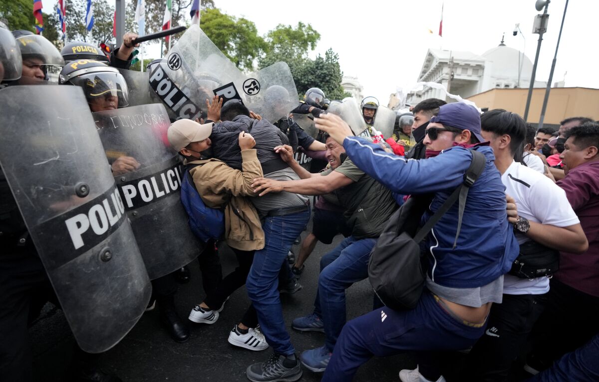 Men clashing with police with shields 