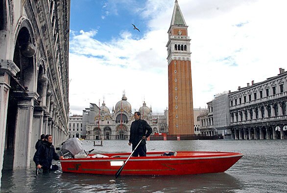 A boat is pressed into use to cope with flooding in Venice's famed St. Mark's Square. The city flooded as a result of one of its highest tides in recorded history--more than 20 inches over flood level.