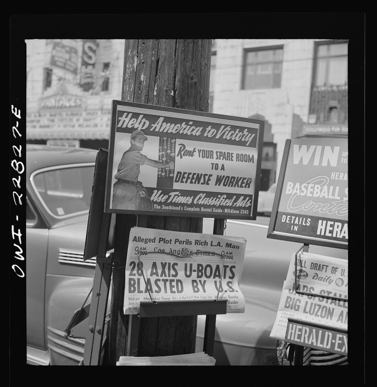 A street-corner newsstand in Los Angeles, bringing the daily news of the war in April 1942.