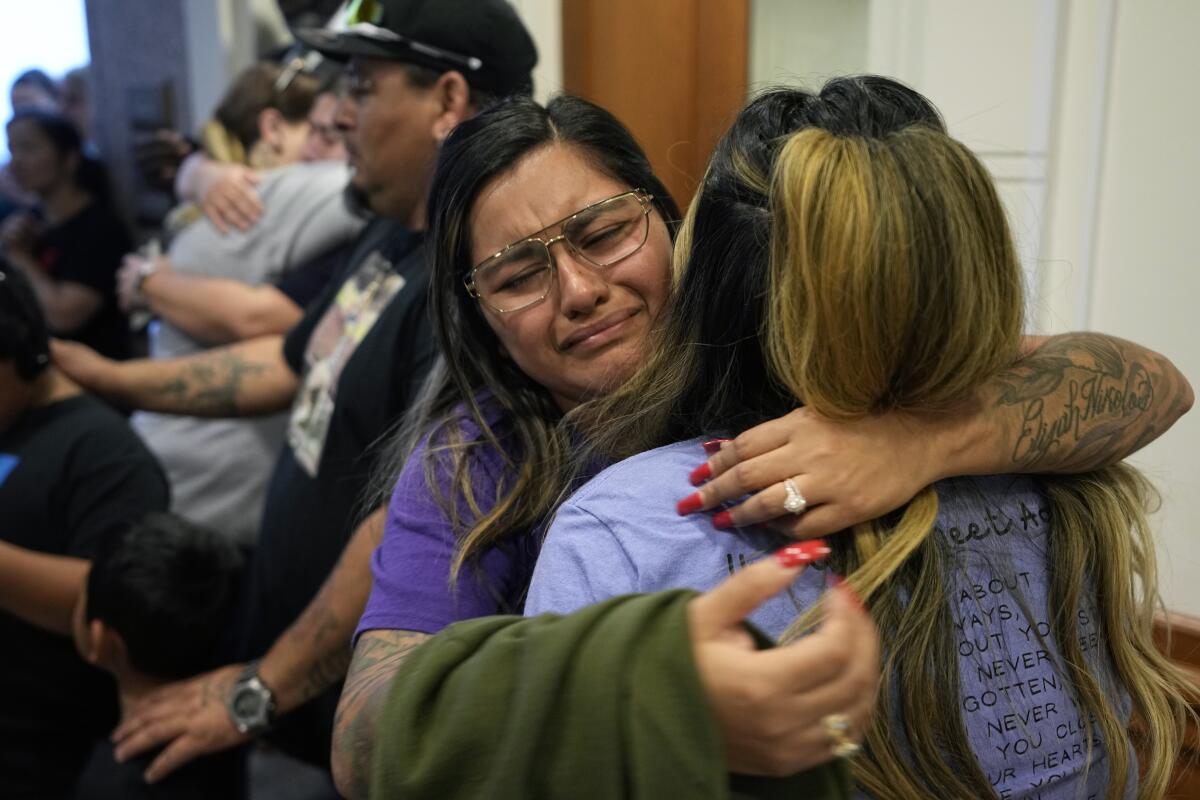 Family members of the victims of the Uvalde, Texas, shootings hug.