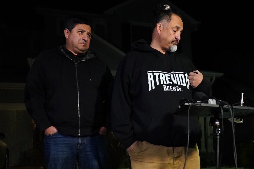 Richard Fierro, right, talks with his brother Ed Fierro about his efforts to subdue the gunman in Saturday's fatal shooting at Club Q, during a news conference Monday, Nov. 21, 2022, outside his home in in Colorado Springs, Colo. (AP Photo/Jack Dempsey)