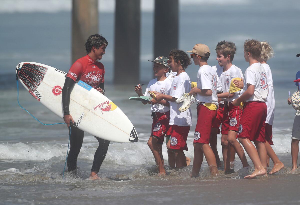 Two-time U.S. Open Champion and Huntington Beach's own Kanoa Igarashi greets members of the junior lifeguard program Tuesday.