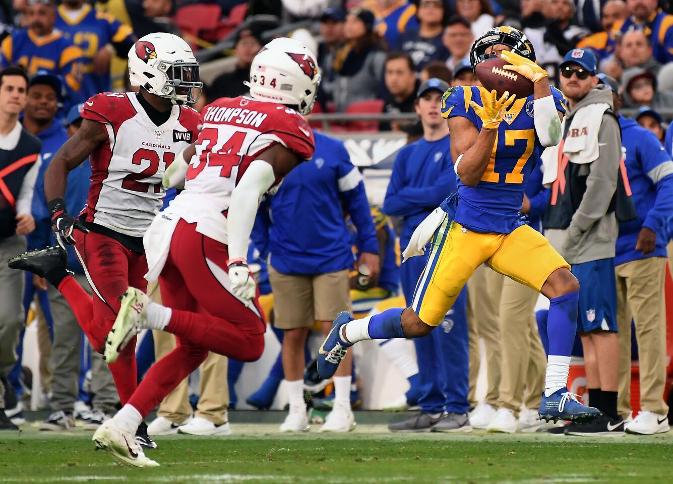 LOS ANGELES, CALIFORNIA DECEMBER 29, 2019-Rams reeiver Robert Woods catches a long pass in fornt of Cardinal defenders Patrick Peterson, left, and Jalen Thompson in the 4th quarter at the Coliseum Sunday. (Wally Skalij/Los Angerles Times)