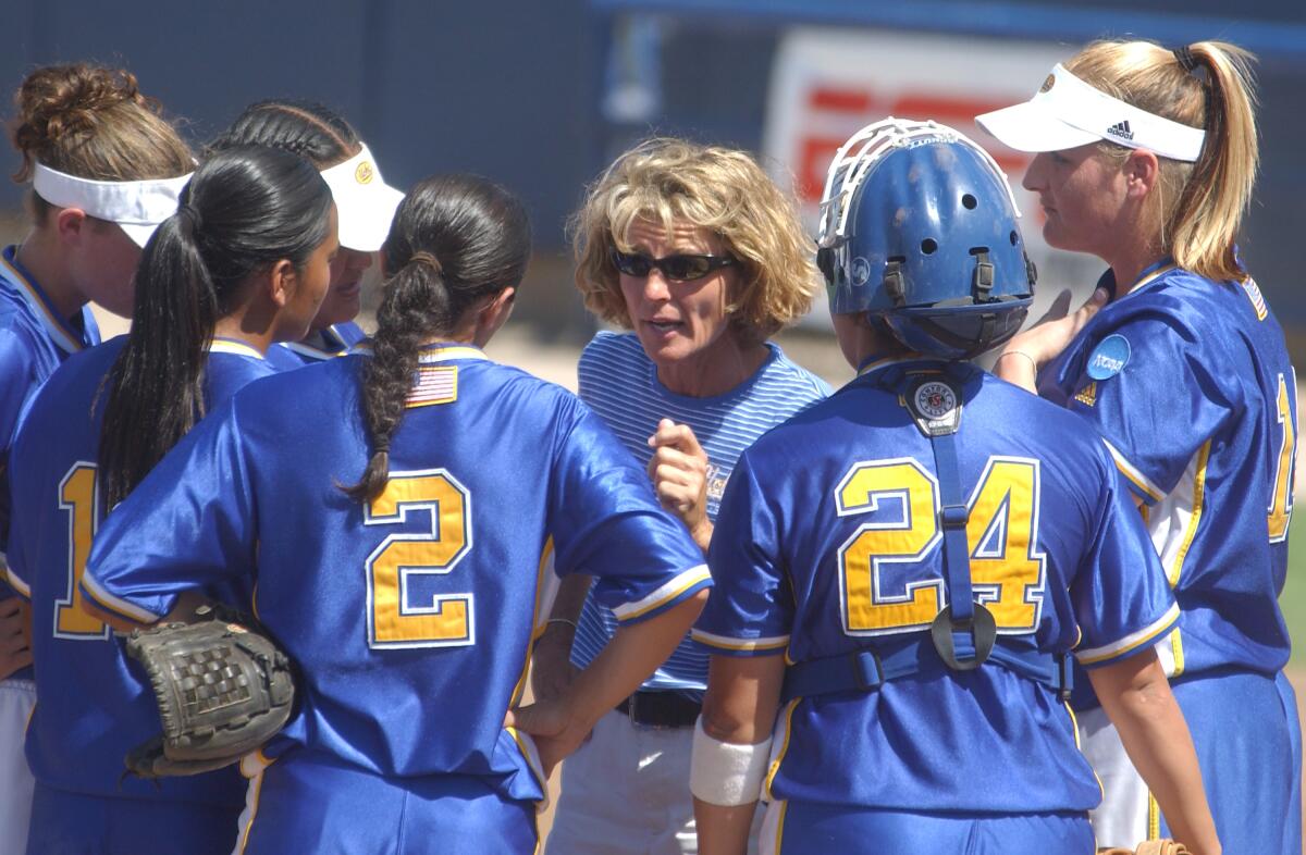 UCLA coach Sue Enquist talks to her team during a timeout against Louisiana State.