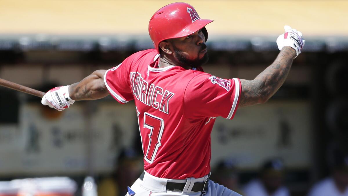 Angels second baseman Howie Kendrick hits a two-run double against the Oakland Athletics on Sept. 24.