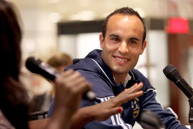 Landon Donovan, right, of the L.A. Galaxy, speaks with ESPN's Kelley Carter, left, during an interview at Macy's South Coast Plaza.