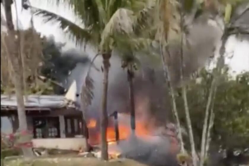 This frame grab from UGC video provided by Felipe Magalhaes Filho shows fire coming from a plane that crashed by a home in Vinhedo, Sao Paulo state, Brazil, Friday, Aug. 9, 2024. (Felipe Magalhaes Filho via AP)