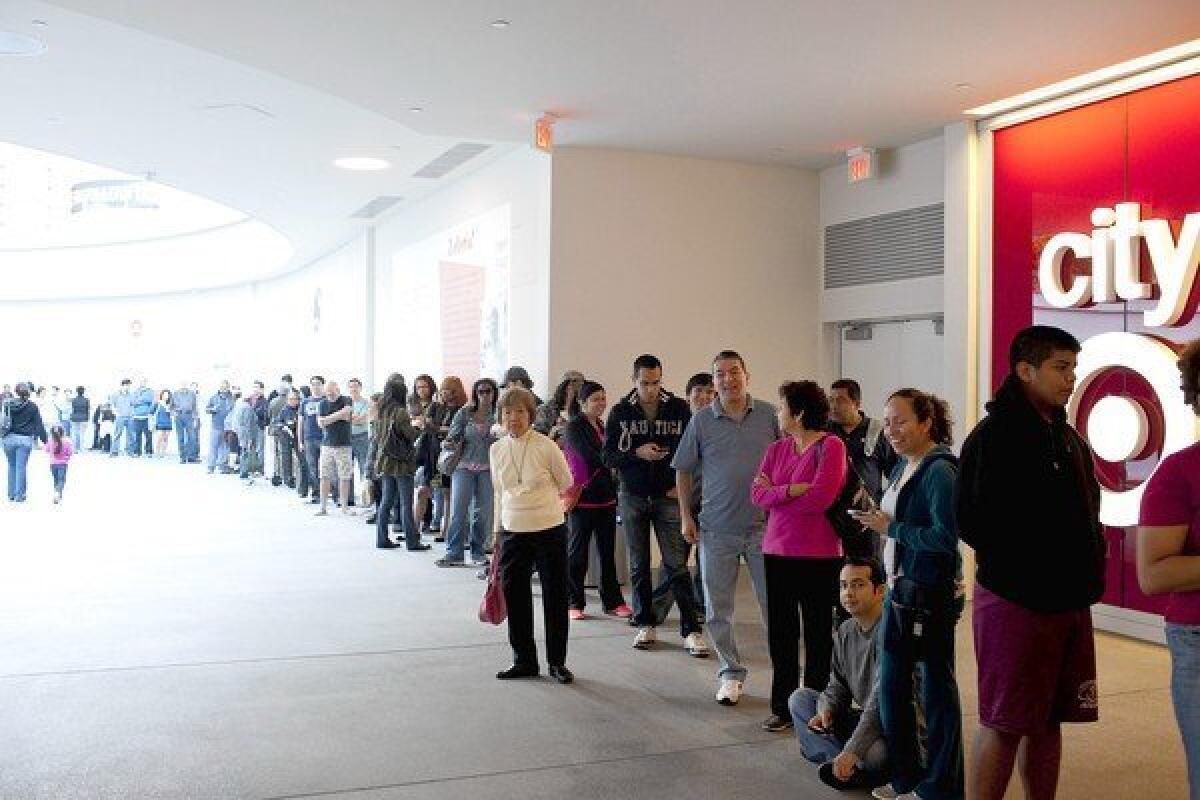A line of shoppers wait outside a Target store in downtown Los Angeles.