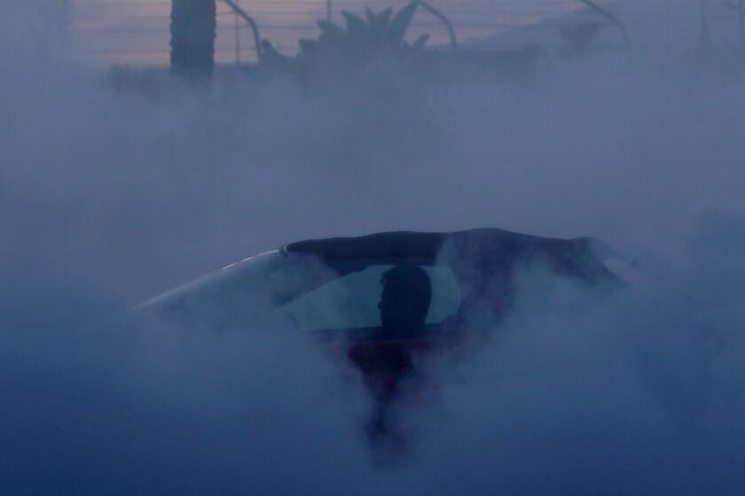 IRWINDALE, CALIF. - APR. 19, 2018. A driver performs donuts while burning rubber in the burnout pad of the Irwindale Speedway in Irwindale on Thursday, April 19, 2018. The track hosts weekly racing and drifting events on Thursdays, which attract hundreds of car enthusiasts and spectators drawn to the speed and horsepower of motor sports. (Luis Sinco/Los Angeles Times)