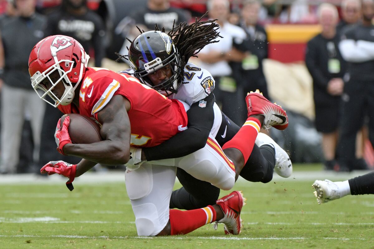 Chiefs receiver Sammy Watkins (14) is tackled by Ravens cornerback Maurice Canady after a reception during the first half Sunday.