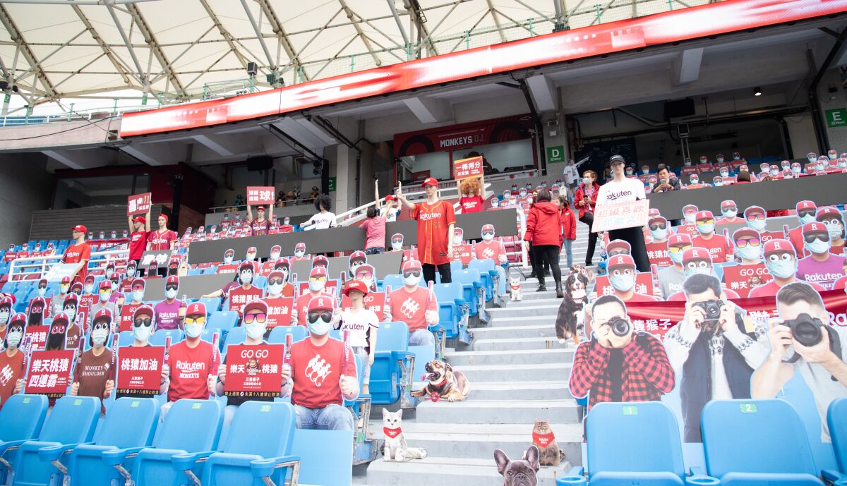 Cardboard cutouts of fans crowd the stands before a scheduled game between the Rakuten Monkeys and the Chinatrust Brothers in Taoyuan, Taiwan, that was rained out on April 11.