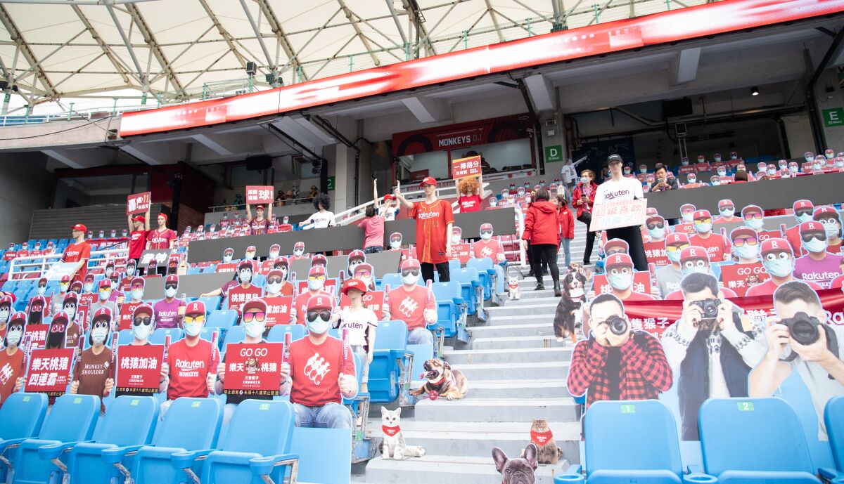 Cardboard cutouts of fans crowd the stands before a scheduled game between the Rakuten Monkeys and the Chinatrust Brothers in Taoyuan, Taiwan, that was rained out on April 11.