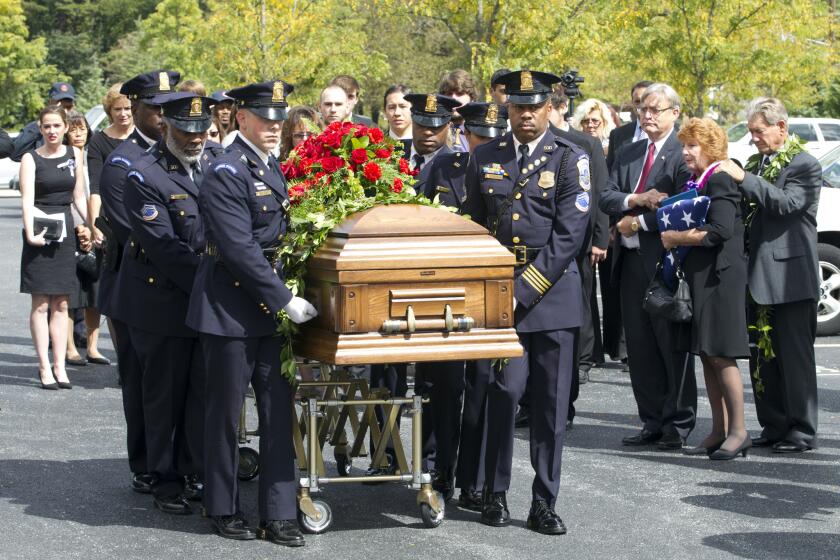 Police officers carry the coffin of Richard Michael Ridgell, 52, of Westminster, Md. after his funeral service on Sept. 28, 2013. Ridgell was one of the 12 victims who died in the Sept. 16, 2013 Washington Navy Yard shootings.