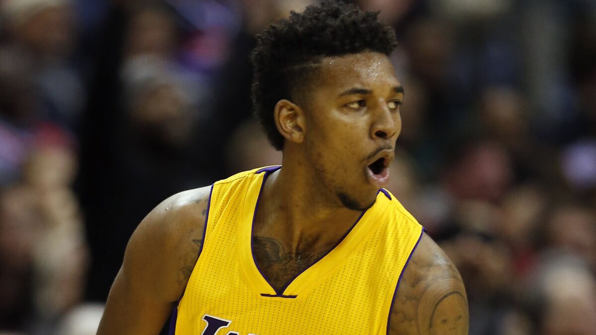 Lakers forward Nick Young celebrates after scoring a three-pointer during a loss to the Washington Wizards on Dec. 3.
