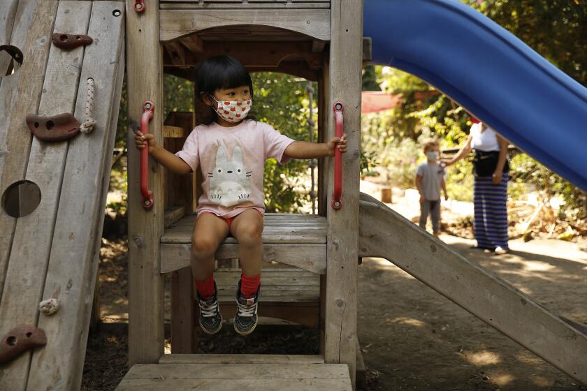LOS ANGELES-AUGUST 27, 2020: A child wears a mask while playing at Voyages Preschool in Los Angeles on Thursday, August 27, 2020. (Christina House / Los Angeles Times)