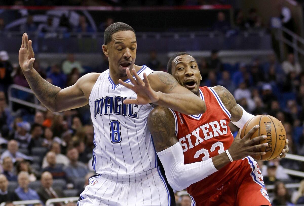 Magic forward Channing Frye (8) is called for a foul as he tries to block 76ers forward Robert Covington's (33) path to the basket.