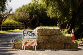 RANCHO PALOS VERDES-CA-FEBUARY 14, 2024: The road is closed on Cinnamon Lane in the Portuguese Bend area of Rancho Palos Verdes due to landslide damage, on Wednesday, February 14, 2024. (Christina House / Los Angeles Times)