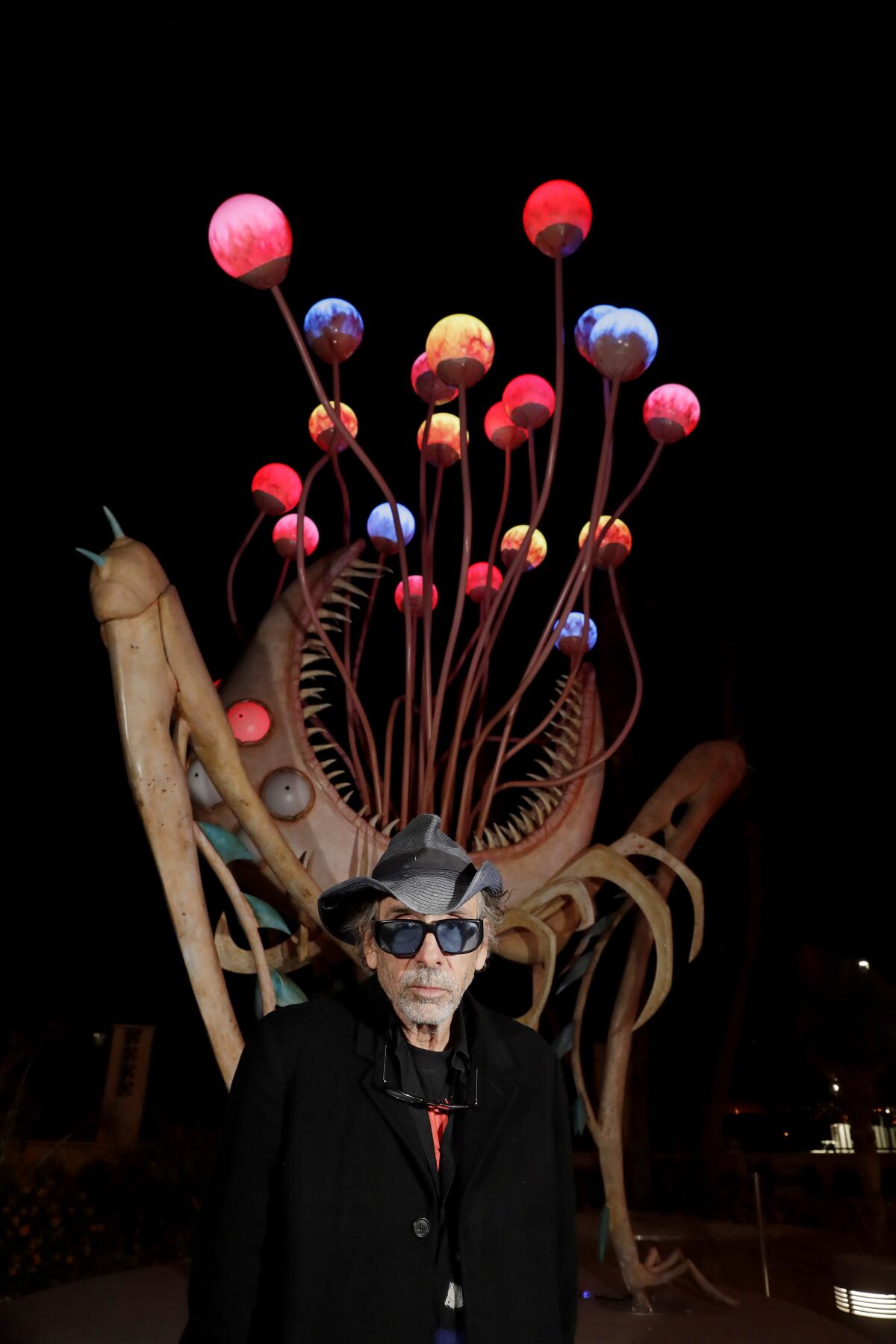 Tim Burton in front of "Orb Monster" at his "Lost Vegas" exhibit at the Neon Museum.