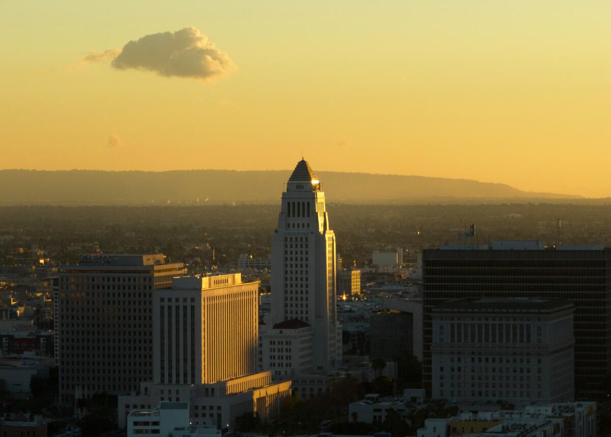 Los Angeles City Hall, at center, aglow at sunset