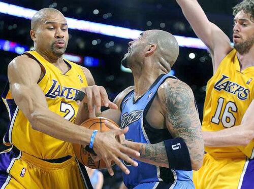 Lakers point guard Derek Fisher strips the ball from Jazz forward Carlos Boozer during the first half Monday night.
