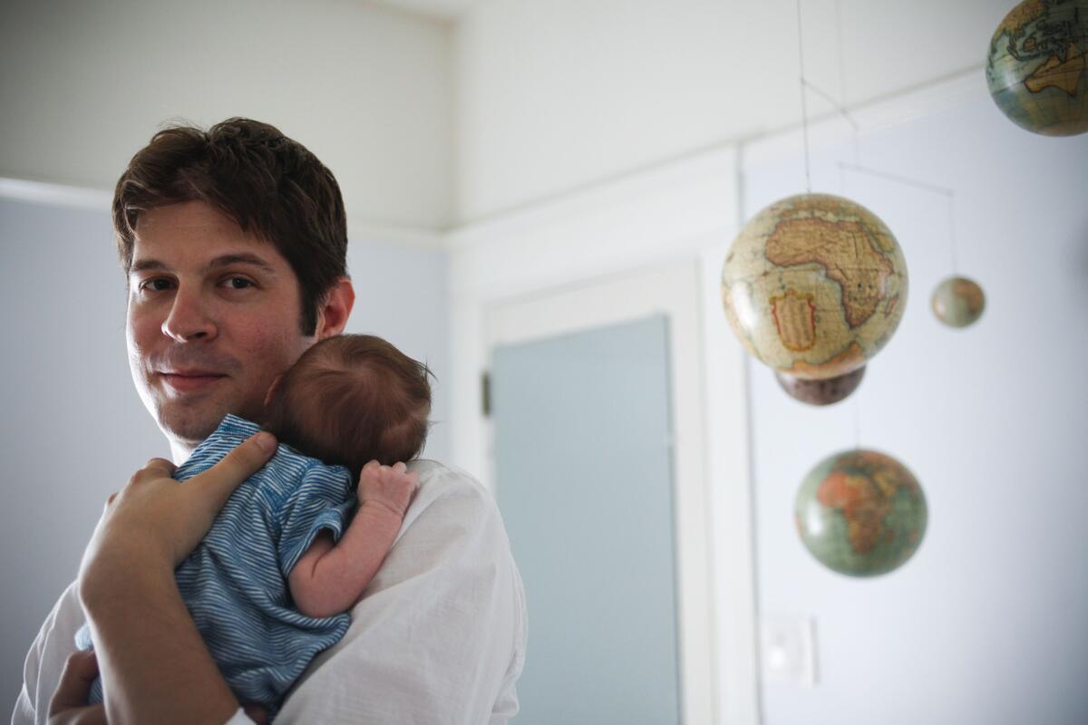 Composer Adam Schoenberg, whose piece "Bounce" will play at the Hollywood Bowl, poses at home with his son.
