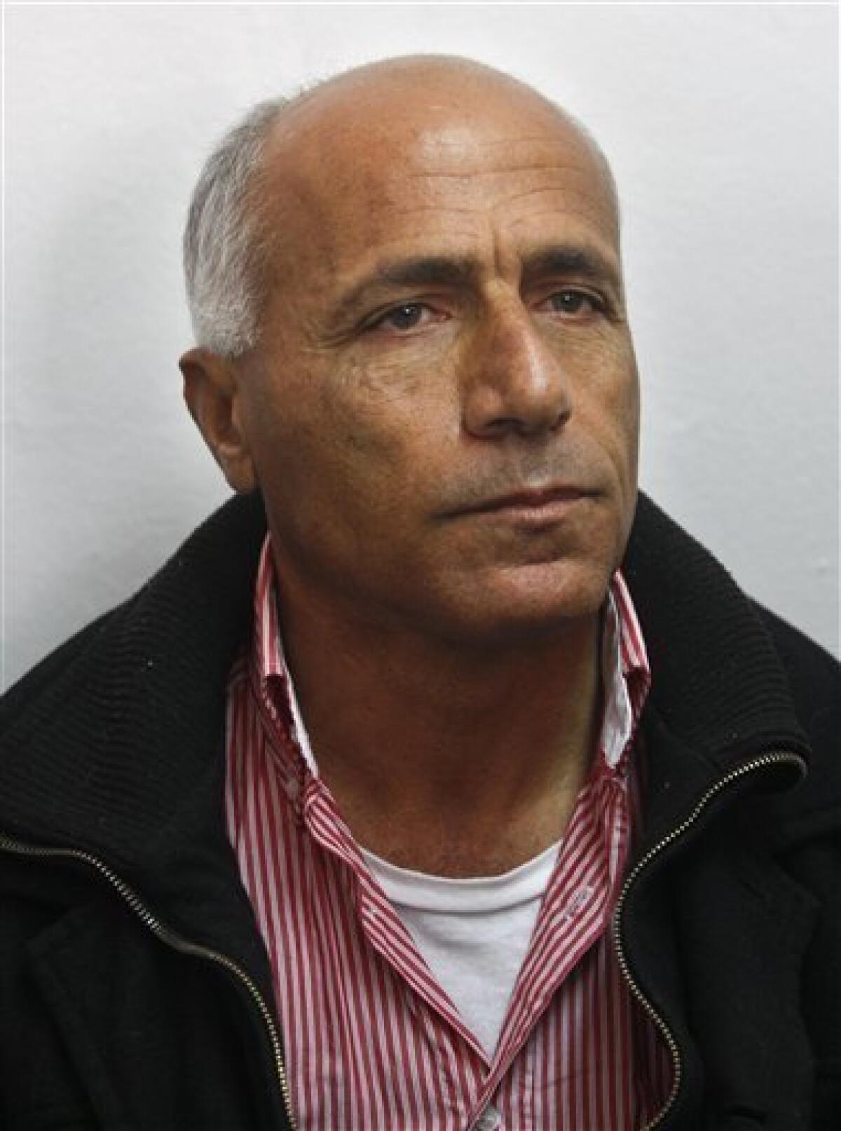 Israeli nuclear whistleblower Mordechai Vanunu waits in a courtroom before a hearing, in Jerusalem, Tuesday, Dec. 29, 2009. Vanunu was put under house arrest Tuesday after being charged with violating a condition of his 2004 release from an Israeli prison. Vanunu was a former low-level technician at an Israeli nuclear plant who leaked details and pictures of the operation to the Sunday Times of London in 1986. Vanunu served 18 years in prison and after his release was banned from leaving the country and having unauthorized contact with foreigners.(AP Photo/Dan Balilty)