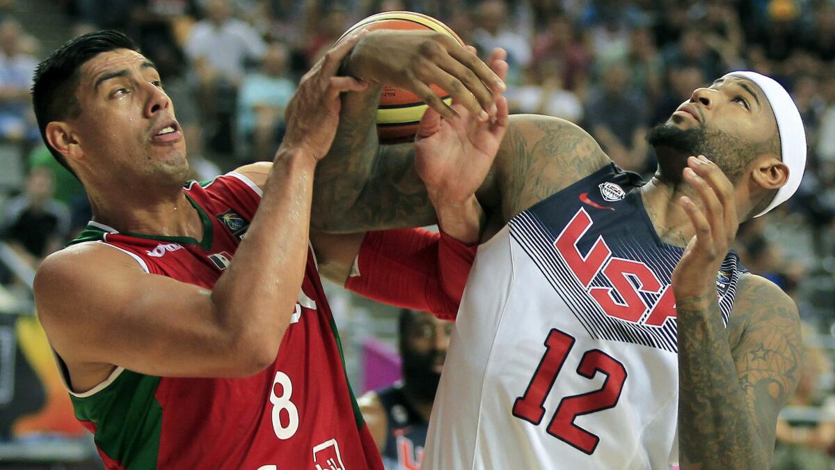 Mexico center Gustavo Ayon, left, and U.S. center DeMarcus Cousins battle for the ball during the USA's 86-63 win in the Basketball World Cup on Saturday.
