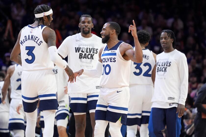Minnesota Timberwolves guard Mike Conley (10) celebrates with teammates during the first half of Game 3 of an NBA basketball first-round playoff series against the Phoenix Suns, Friday, April 26, 2024, in Phoenix. (AP Photo/Matt York)