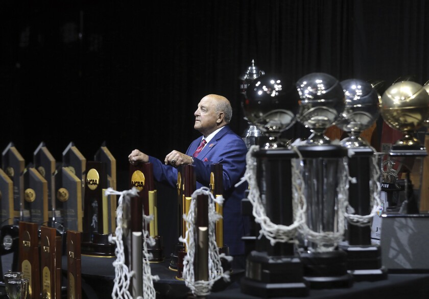 University of Wisconsin Athletic Director Barry Alvarez is pictured among some of the championship trophies won by the university's sports teams during his tenure as a coach and athletic director at an event marking his retirement announcement at the Kohl Center in Madison, Wis. Tuesday, April 6, 2021. (John Hart/Wisconsin State Journal via AP)