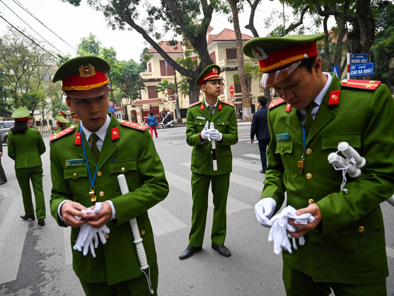 Vietnamese security personnel stand guard outside the North Korean embassy in Hanoi, ahead of the second U.S.-North Korean summit.