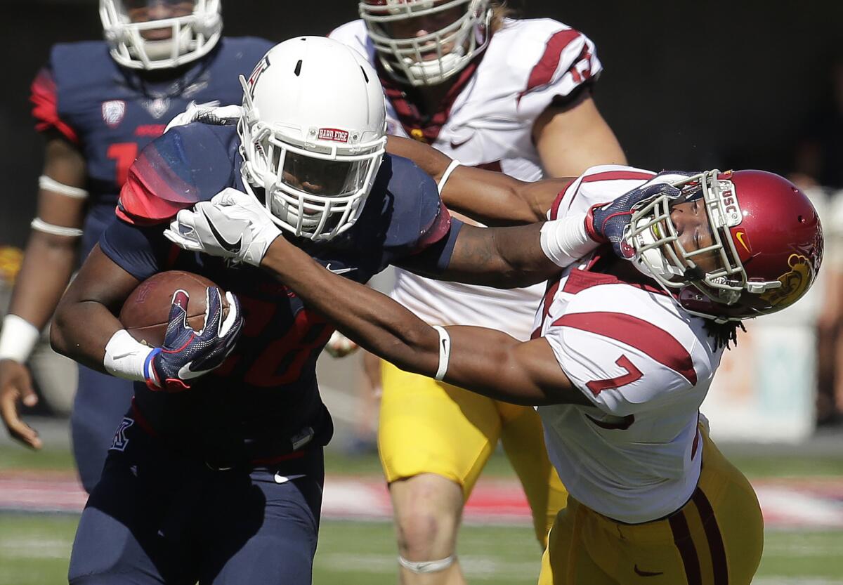 Arizona running back Nick Wilson stiff arms USC defensive back Marvell Tell III (7) during the first half of a game on Oct. 15.