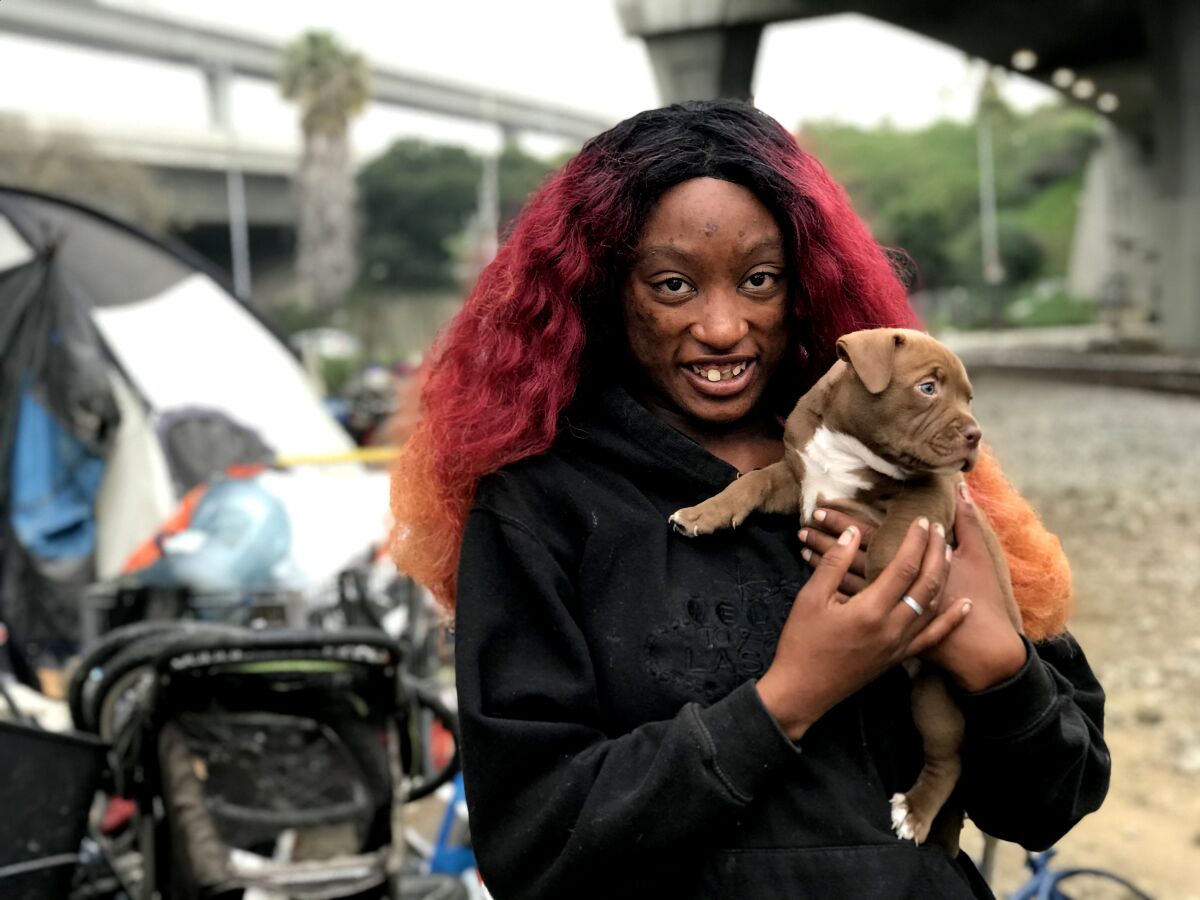 Kiki, 25, with her puppy, Ruby. Kiki’s caseworker has urged her to take advantage of LA DOOR's services, and she did allow a nurse to take her to a medical appointment.