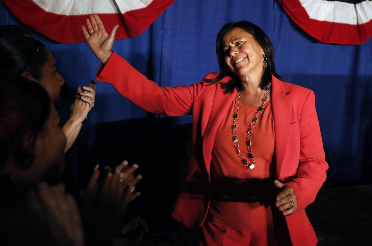 Democratic state Sen. Angela Giron waves to supporters as she gives her concession speech after she lost in a recall vote in Pueblo, Colo.