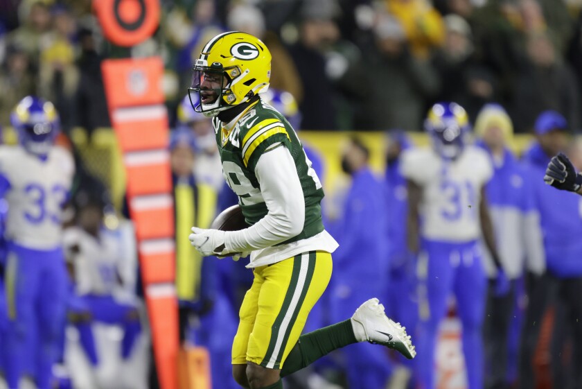 Green Bay Packers' Rasul Douglas runs for a touchdown after after intercepting a Matthew Stafford pass in the second half.