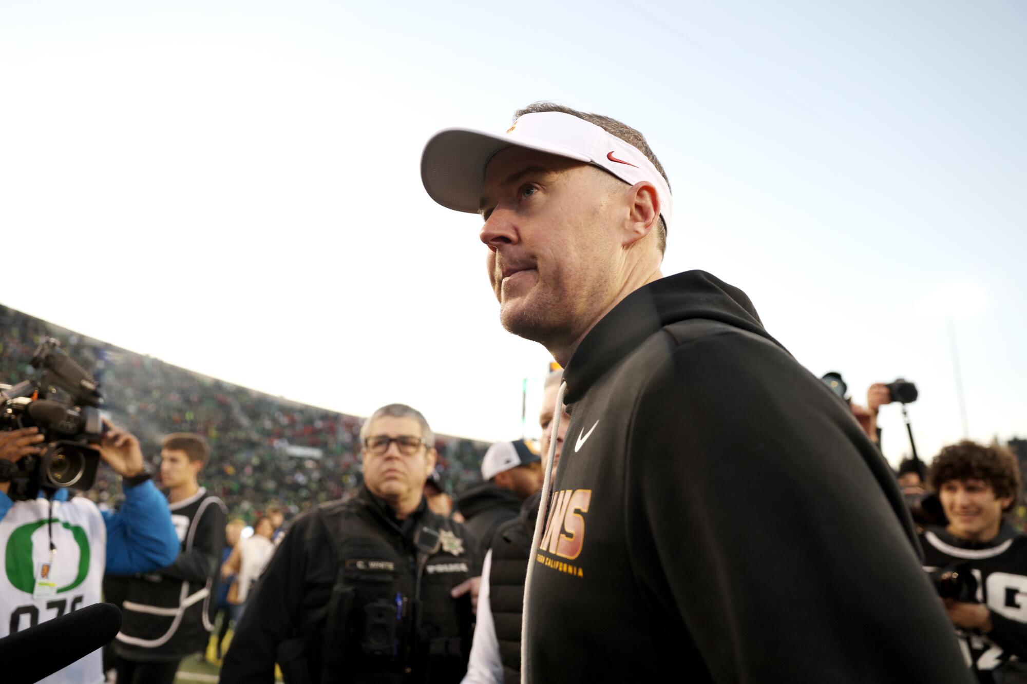 USC coach Lincoln Riley walks off the field after a 42-27 loss to Oregon on Saturday.