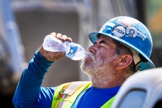 Irvine, CA - September 05: A construction worker takes a water break while digging a trench with a shovel amidst a heat wave in Irvine Thursday, Sept. 5, 2024. (Allen J. Schaben / Los Angeles Times)