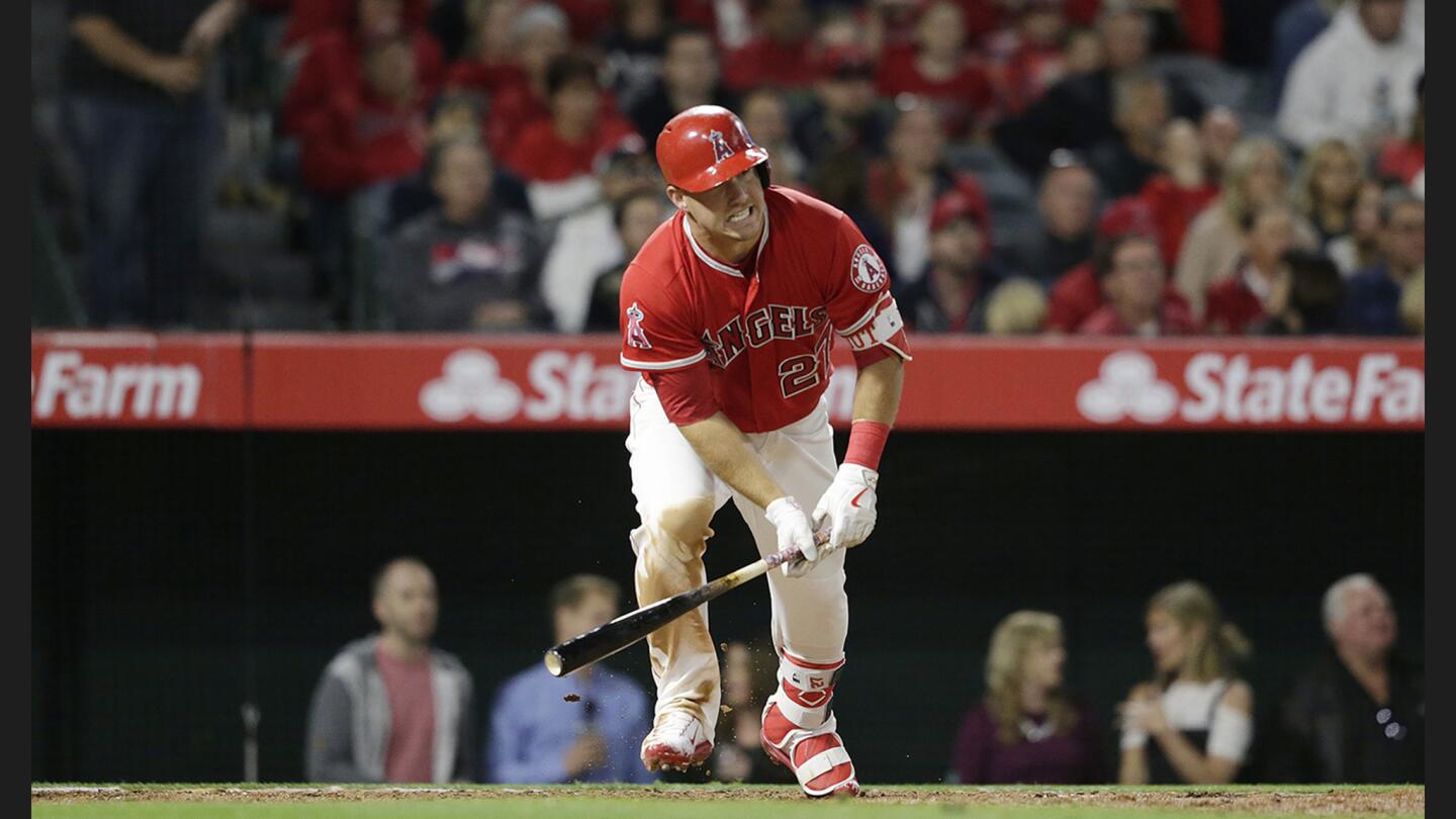 Angels center fielder Mike Trout hits a single in the fifth inning of a game against the Mariners on April 7 at Angel Stadium of Anaheim.