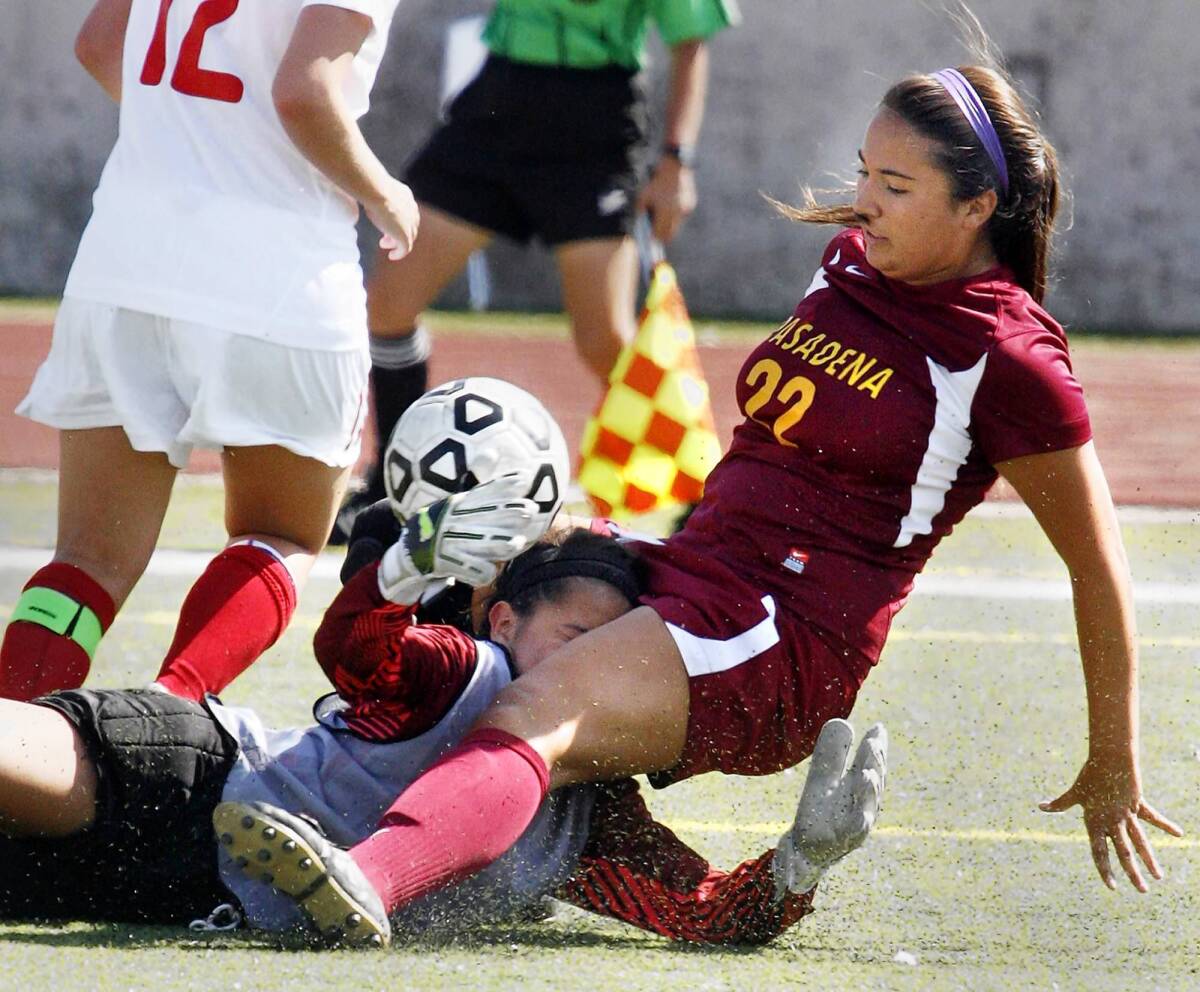 GCC keeper Samantha Galvan dives and blindly reaches to block the shot of PCC's Cassandra Orozco in the first half against Pasadena City College on Tuesday.