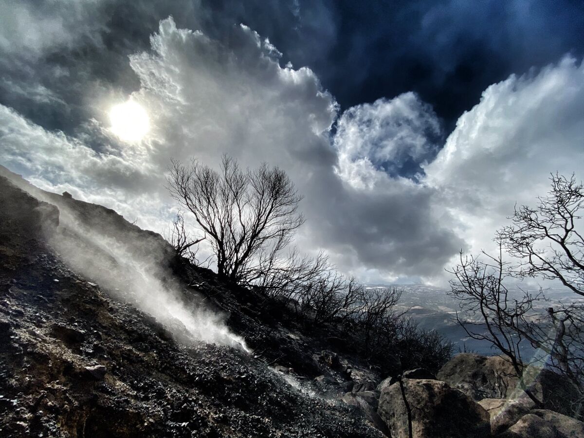 Hillside charred by the Cave fire smolders in Santa Barbara County