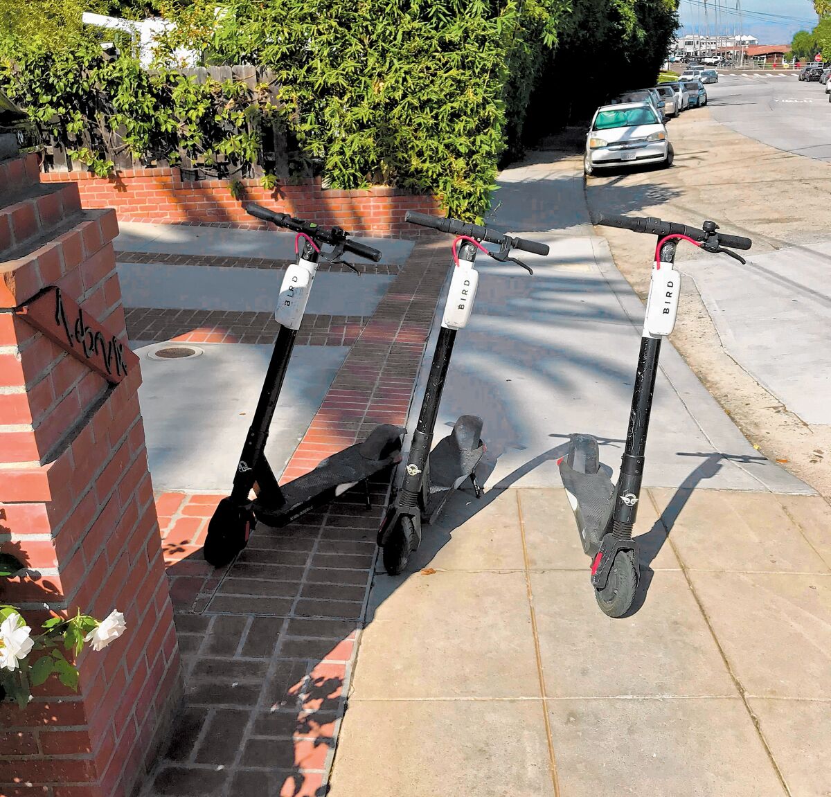 Scooter blockade: This photograph was taken on Saturday morning, Oct. 26, 2019 near my house on the 7800 block of Exchange Place. The sidewalk is completely blocked by these electric scooters. Isn’t this against the law? — Guido Baccaglini