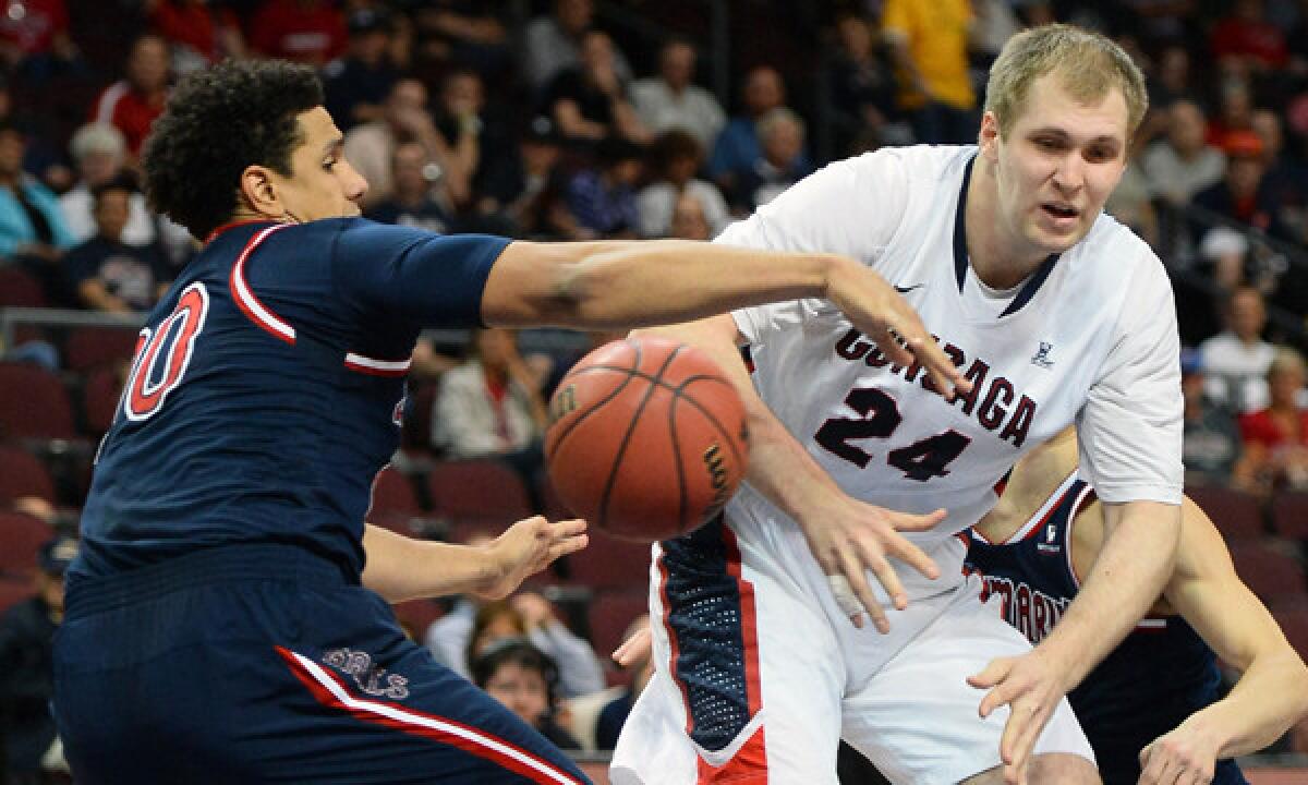 Saint Mary's Brad Waldow, left, strips the ball from Gonzaga's Przemek Karnowski during Gonzaga's 70-54 win in the semifinals of the West Coast Conference tournament on Monday.