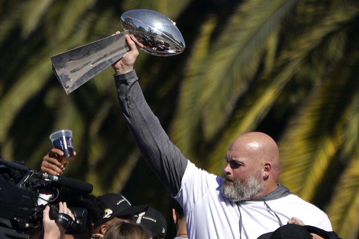 Rams offensive lineman Andrew Whitworth holds up the Vince Lombardi trophy.