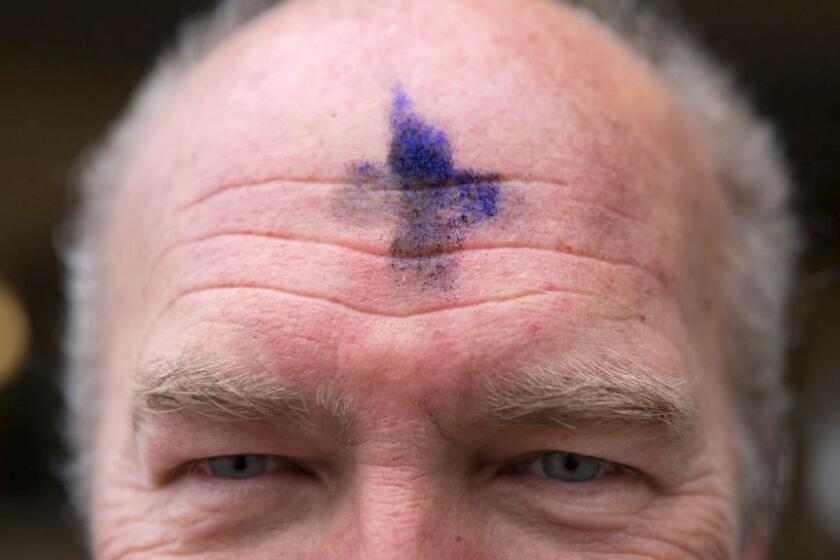 Jon Grondahl of Unity Lutheran Church in Chicago is marked with a cross of ashes mixed with purple glitter for Ash Wednesday. The glitter is a sign of support for the LGBTQ community.