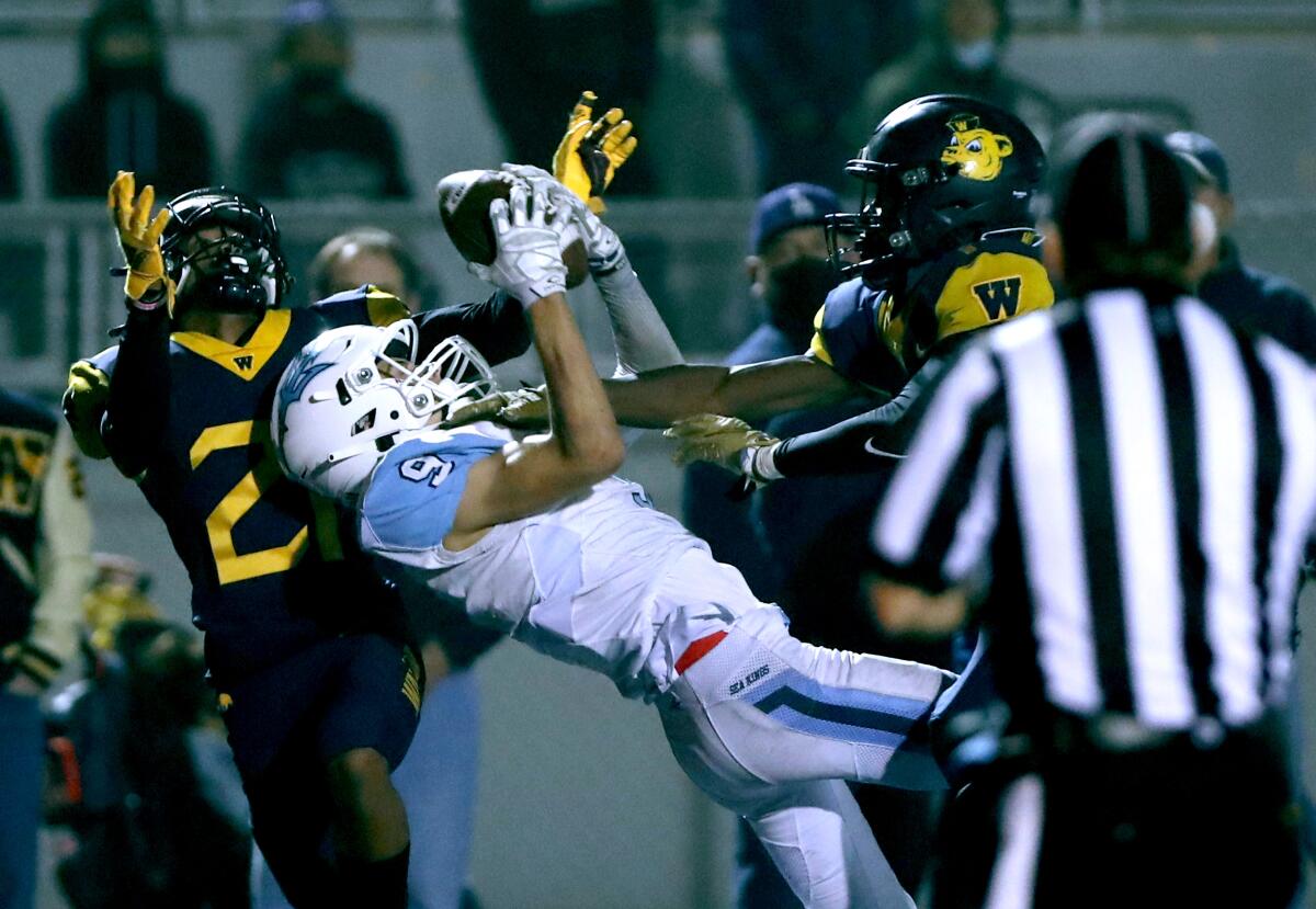 Corona del Mar's Cooper Hoch catches a Hail Mary pass to seal the win late in the fourth quarter against Downey Warren.