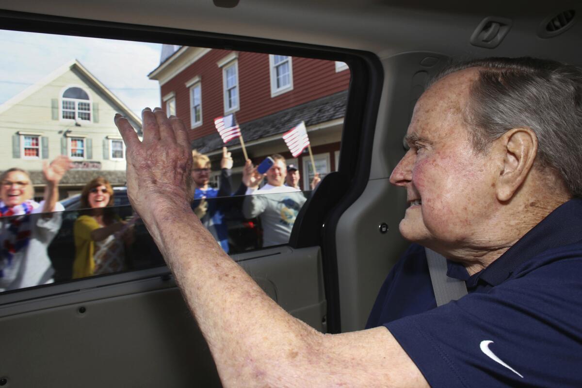 Former President George H.W. Bush waves to supporters as his motorcade arrives in Kennebunkport, Maine on May 20.