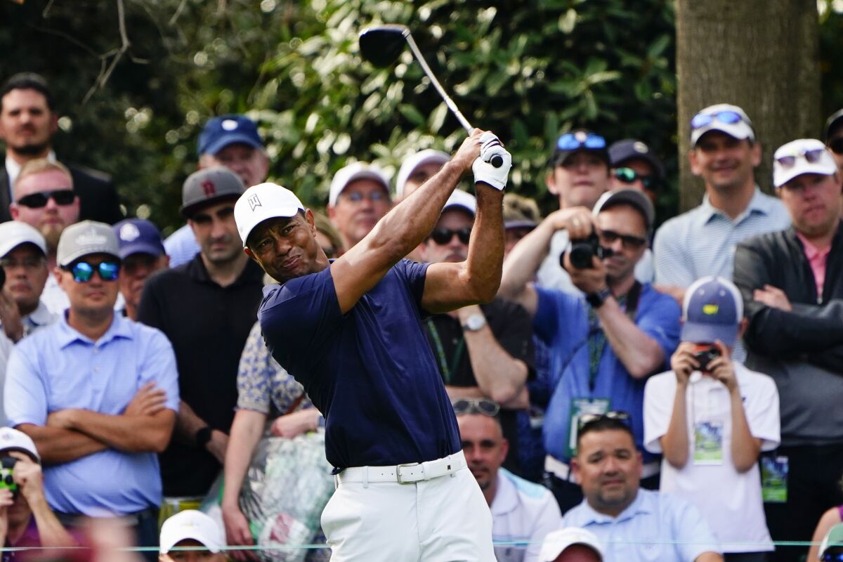 Tiger Woods tees off on the seventh hole during a practice round for the Masters golf tournament .