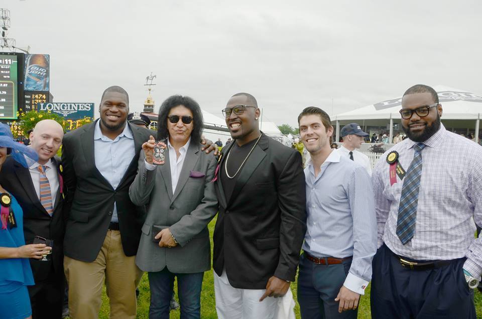Raven Kelechi Osemele (second from left), Gene Simmons of KISS and Ravens players Arthur Jones, Justin Tucker and Michael Oher pose for a photo at the Preakness.