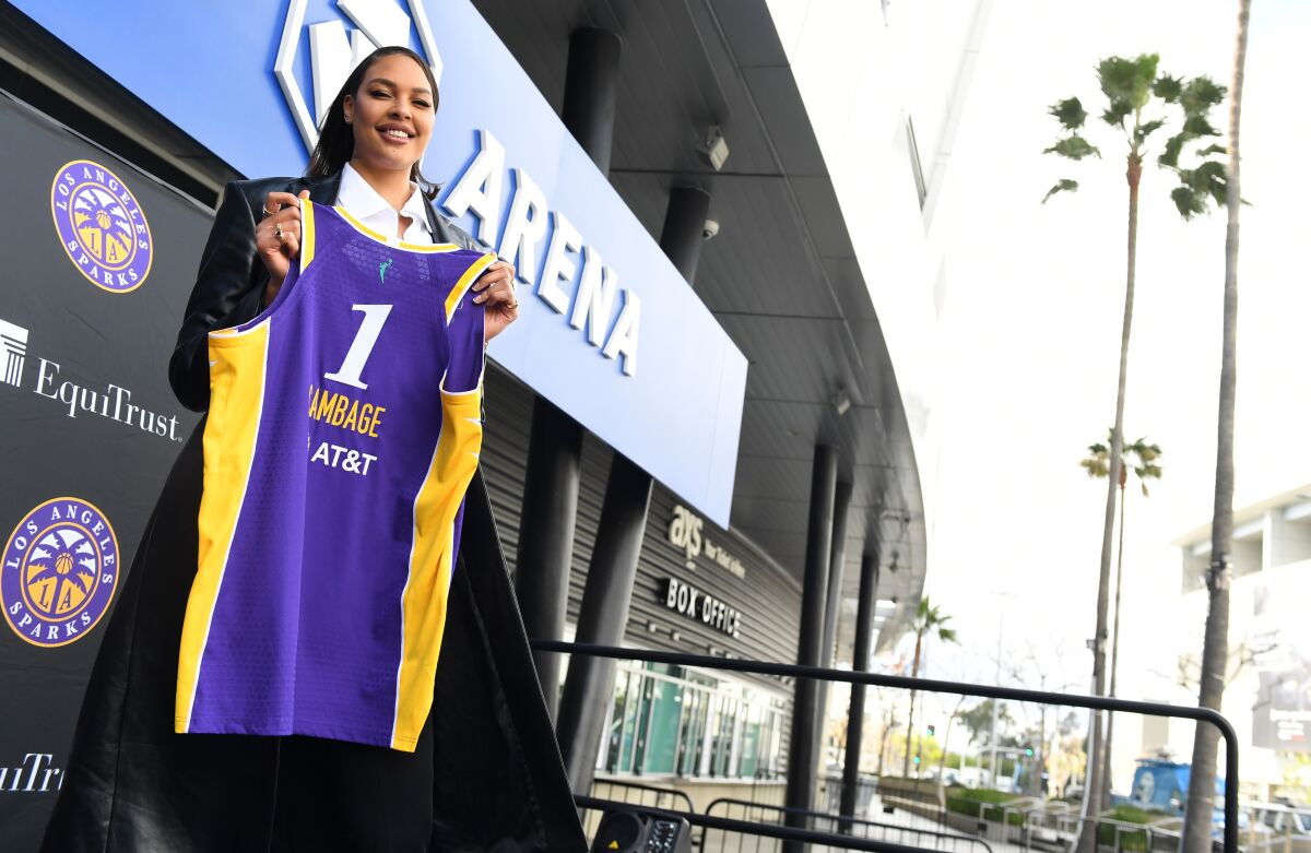 New Sparks player Liz Cambage holds her jersey outside of Crypto.com Arena.
