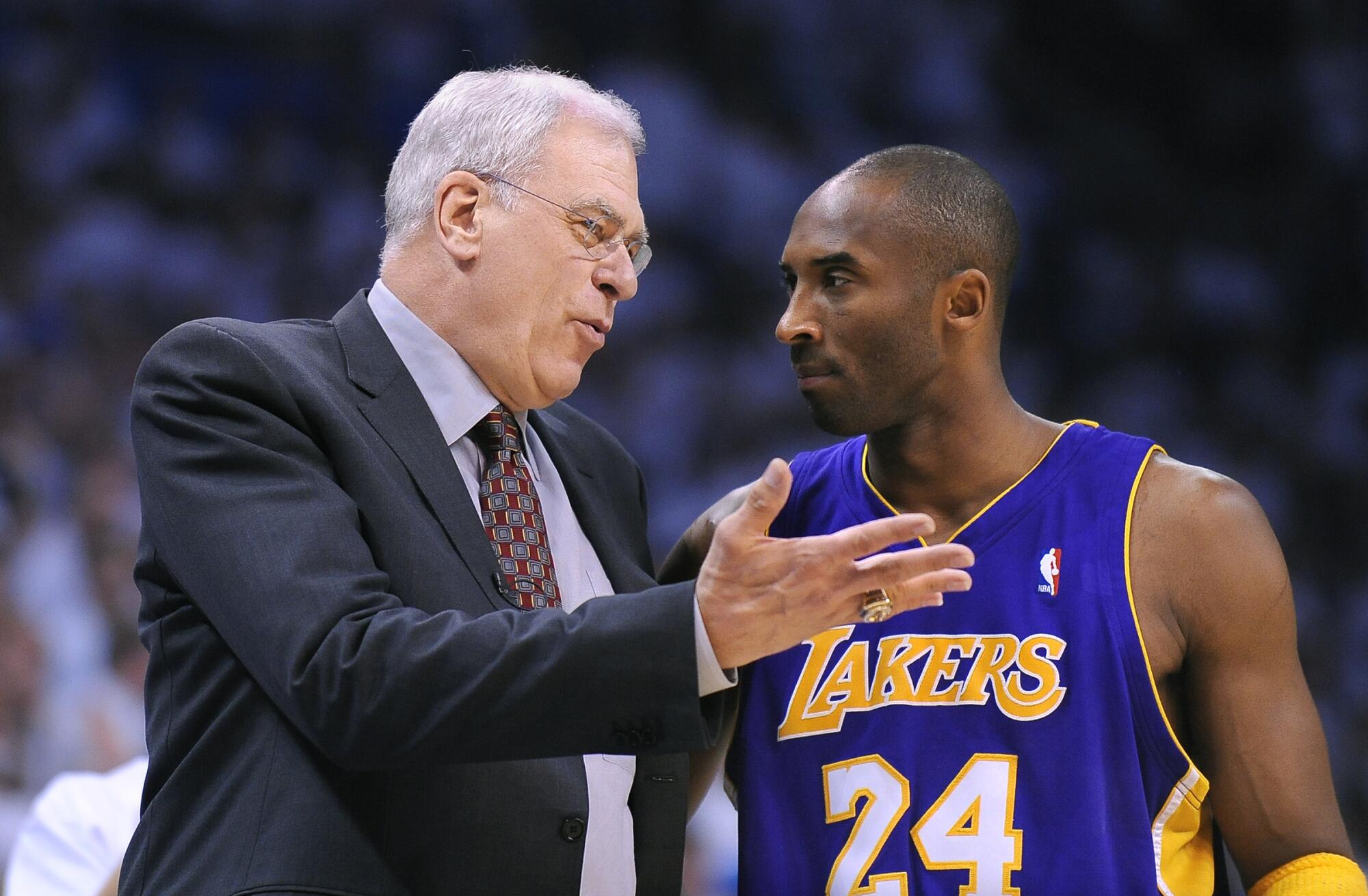 Lakers coach Phil Jackson has a few words with Kobe Bryant during a playoff game.